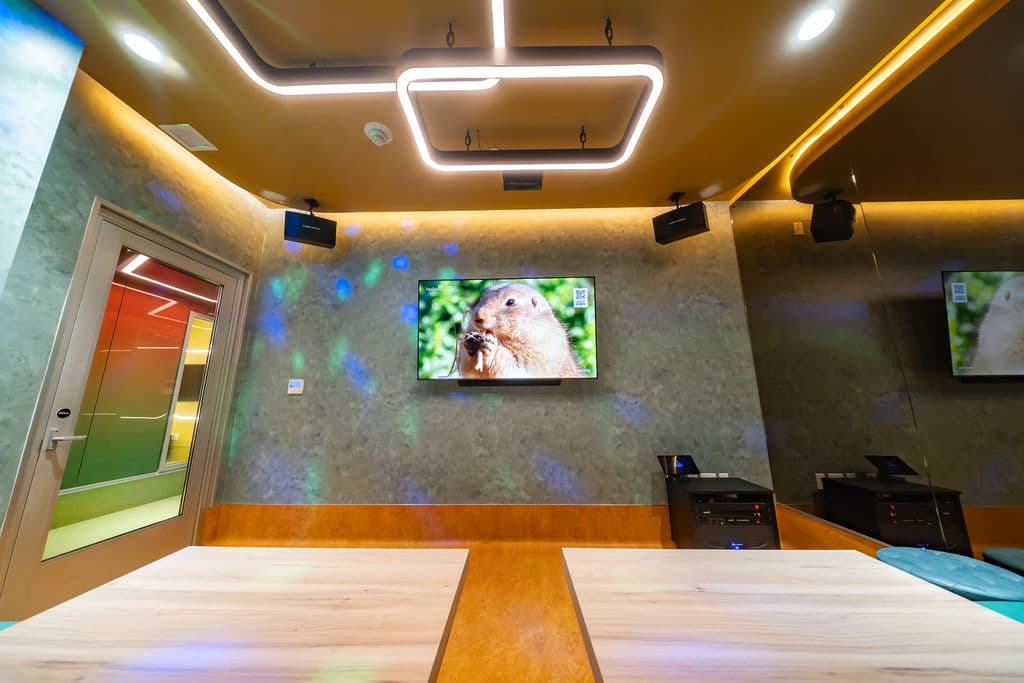 Screen wall with the mic and tablet cabinet below it