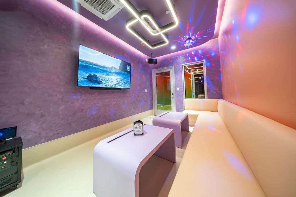 Lavender room with cream seating and tables set for the night