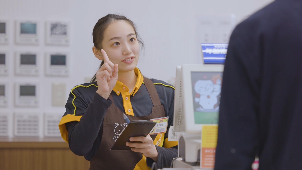 A staff member sharing a tip with a guest at the front desk