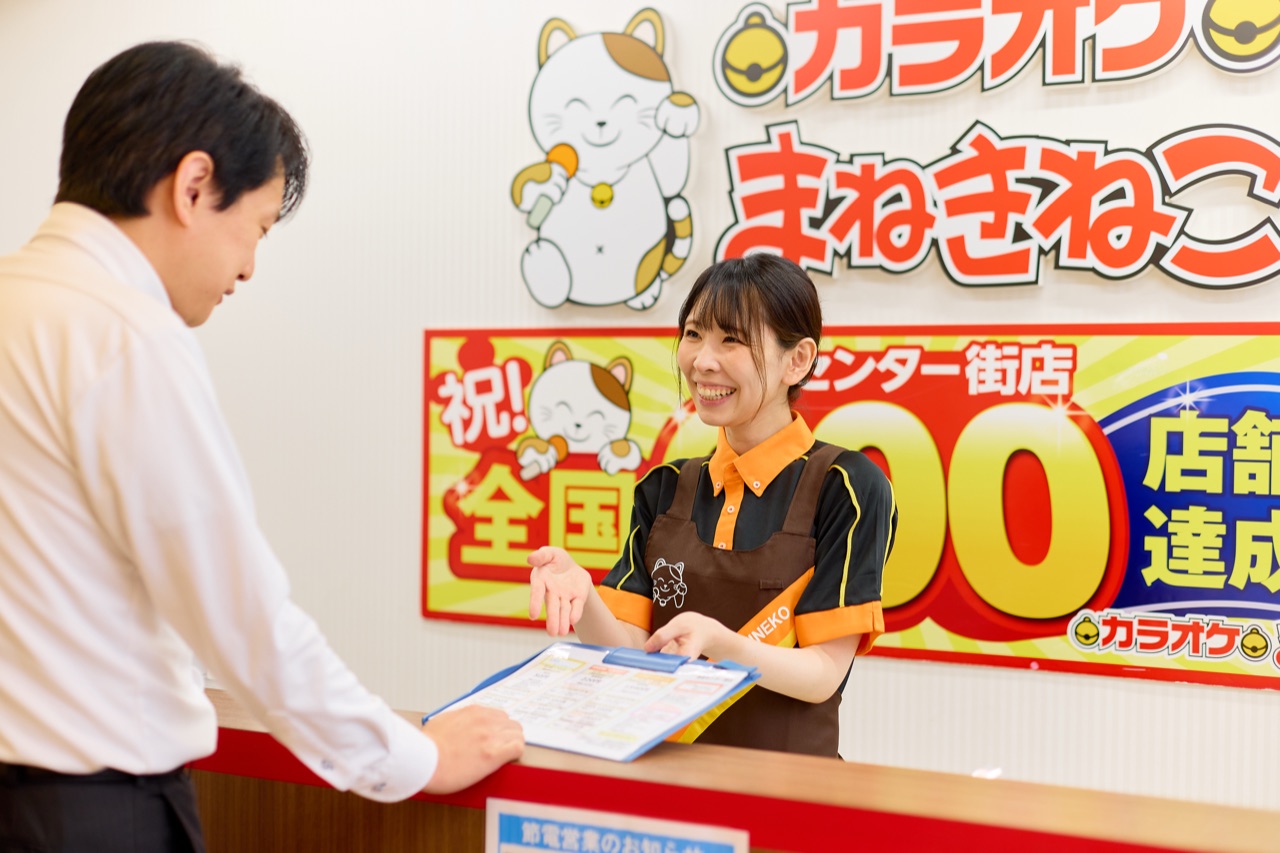 A staff member walking a guest through the menu at check-in